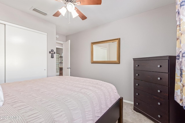 carpeted bedroom with ceiling fan and a closet