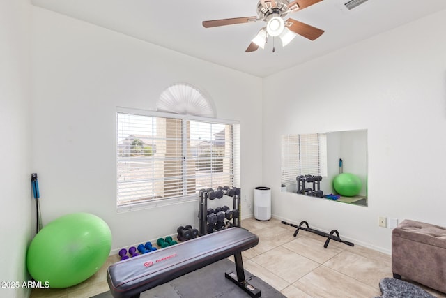 workout room featuring ceiling fan and light tile patterned floors