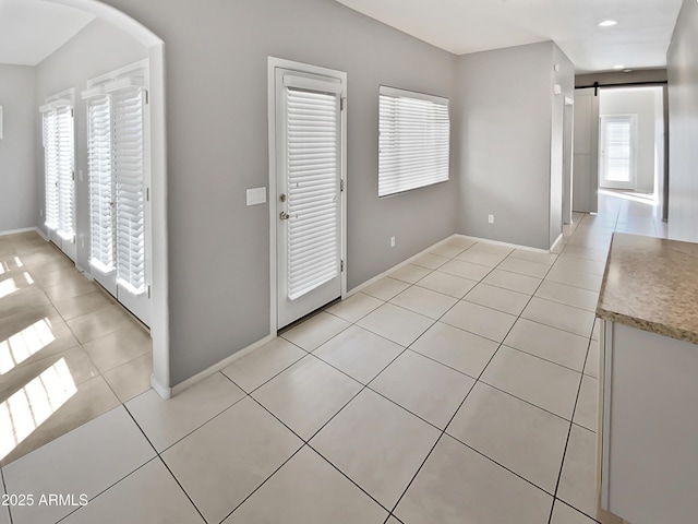 tiled entrance foyer with a barn door