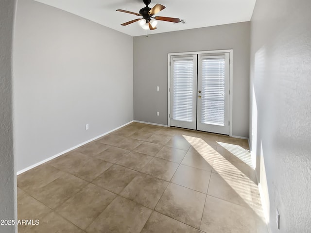 tiled empty room with ceiling fan and french doors