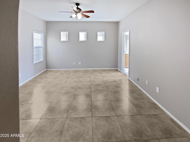 spare room featuring light tile patterned floors and ceiling fan