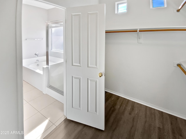 interior space with shower with separate bathtub and hardwood / wood-style floors