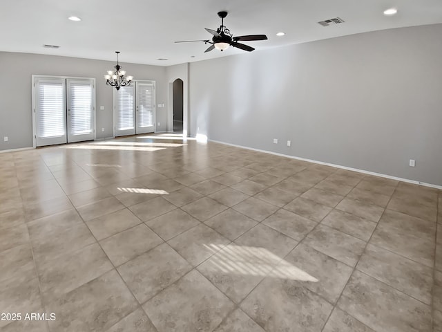 empty room featuring ceiling fan with notable chandelier and light tile patterned floors