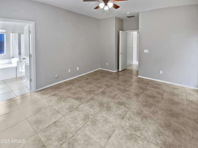 tiled spare room with ceiling fan