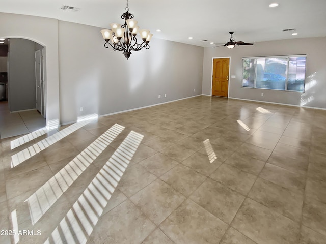 spare room with ceiling fan with notable chandelier and light tile patterned floors