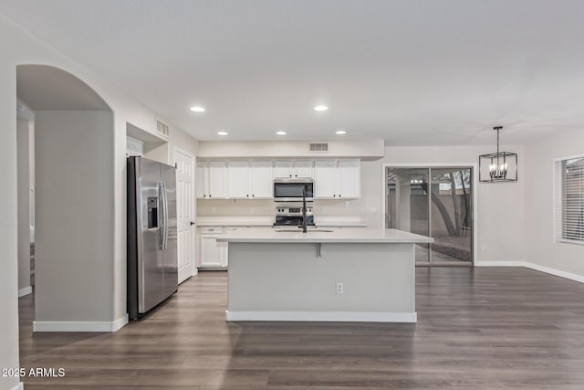 kitchen with stainless steel appliances, light countertops, a sink, and visible vents