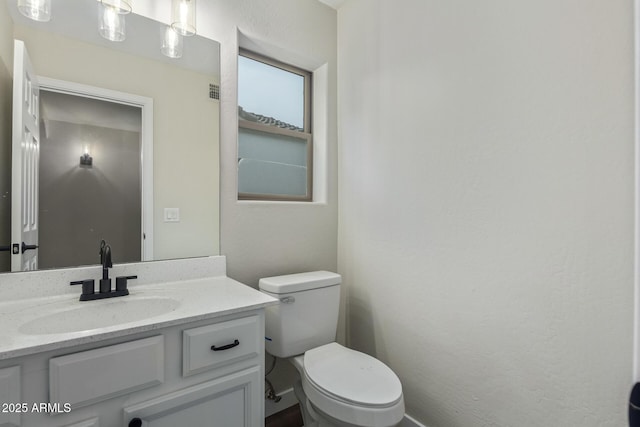 half bath with vanity and toilet