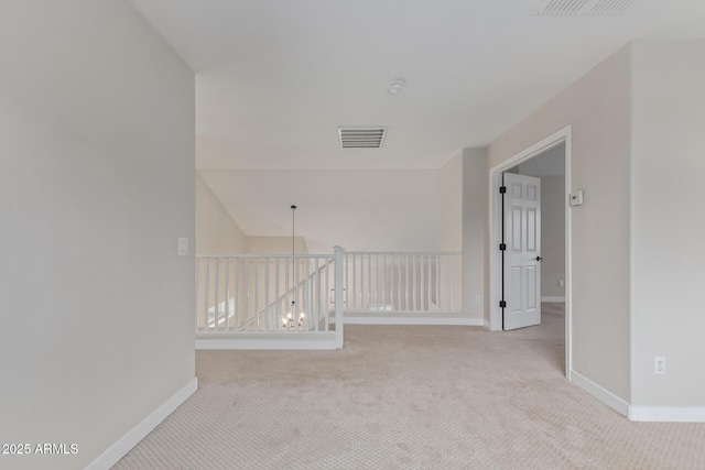 unfurnished room with carpet floors, baseboards, and visible vents