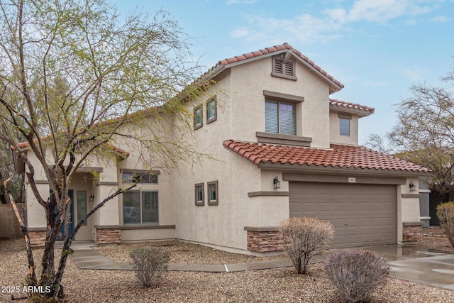 mediterranean / spanish-style house featuring a tile roof, driveway, an attached garage, and stucco siding