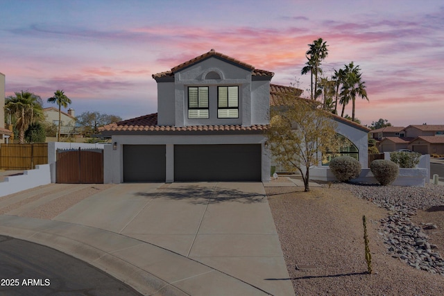 mediterranean / spanish-style house with a garage