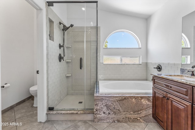 full bathroom with plus walk in shower, vanity, tile patterned floors, and toilet