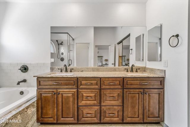 bathroom with vanity and independent shower and bath