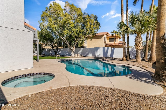 view of pool featuring a patio area and an in ground hot tub