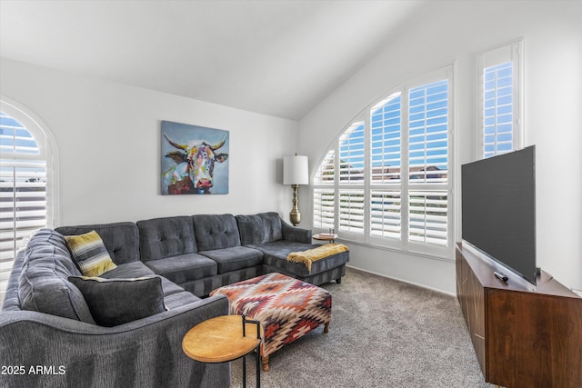 carpeted living room featuring lofted ceiling