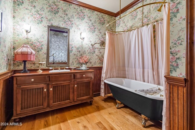 bedroom with crown molding and light hardwood / wood-style flooring