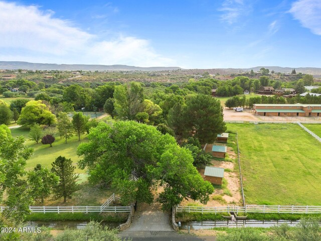 birds eye view of property with a water view and a rural view