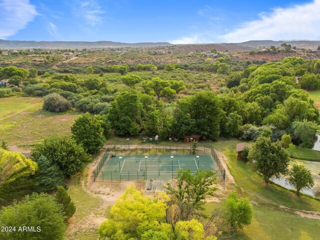 back of property with a balcony and a lawn