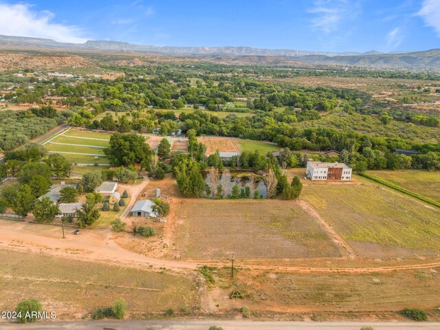 birds eye view of property featuring a mountain view and a rural view