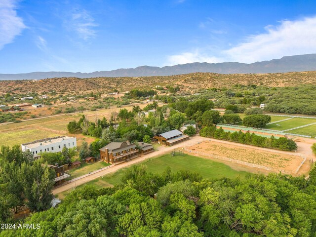 birds eye view of property with a mountain view and a rural view