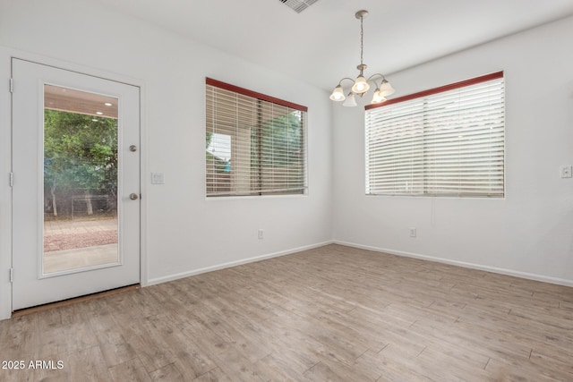 16215 W Durango St, Goodyear, AZ 85338 - spare room with a chandelier, light wood-style flooring, and healthy amount of natural light