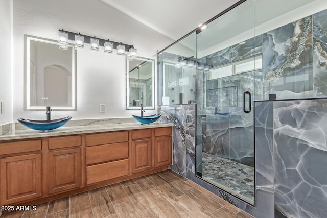 16215 W Durango St, Goodyear, AZ 85338 - bathroom with a marble finish shower, wood finish floors, and double vanity