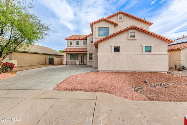 16215 W Durango St, Goodyear, AZ 85338 - mediterranean / spanish-style home with a tile roof, stucco siding, concrete driveway, and fence