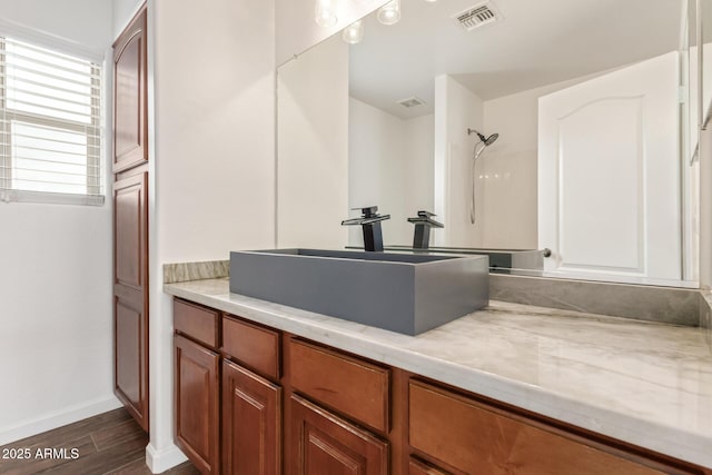 16215 W Durango St, Goodyear, AZ 85338 - full bathroom featuring wood finished floors, baseboards, a shower, and vanity