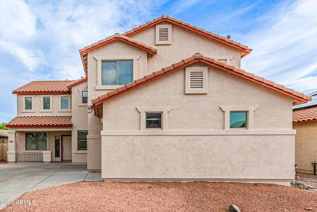 16215 W Durango St, Goodyear, AZ 85338 - view of home's exterior featuring a tiled roof, stucco siding, and a patio