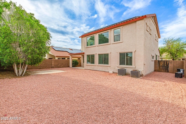 16215 W Durango St, Goodyear, AZ 85338 - rear view of house featuring a fenced backyard, stucco siding, central AC, and a gate