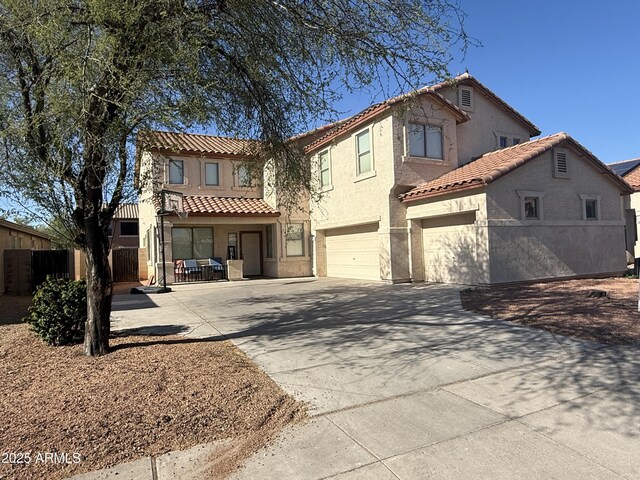 16215 W Durango St, Goodyear, AZ 85338 - view of front of house featuring a tiled roof, driveway, a garage, and stucco siding