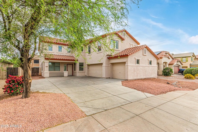 16215 W Durango St, Goodyear, AZ 85338 - view of front facade featuring a garage, a tile roof, stucco siding, fence, and concrete driveway