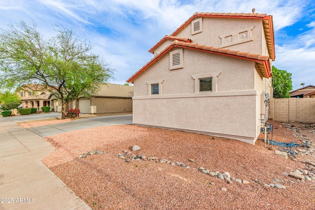 16215 W Durango St, Goodyear, AZ 85338 - view of side of property featuring stucco siding, fence, and a tile roof