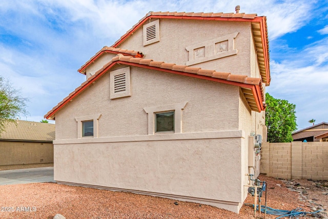 16215 W Durango St, Goodyear, AZ 85338 - view of property exterior with fence, stucco siding, and a tile roof