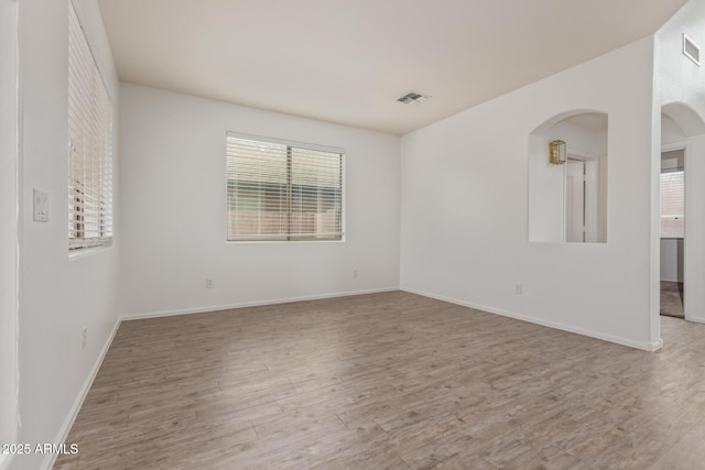16215 W Durango St, Goodyear, AZ 85338 - spare room with wood finished floors, arched walkways, and baseboards