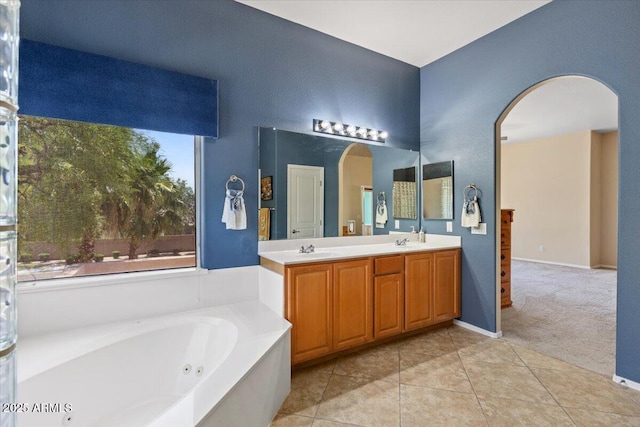 5212 S Monte Vista St, Chandler, AZ 85249 - bathroom featuring double vanity, a tub with jets, tile patterned flooring, and baseboards