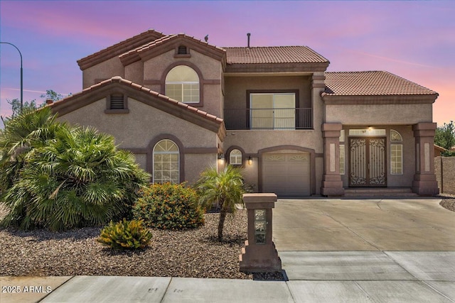 5212 S Monte Vista St, Chandler, AZ 85249 - mediterranean / spanish-style house featuring concrete driveway, a balcony, a tile roof, and stucco siding