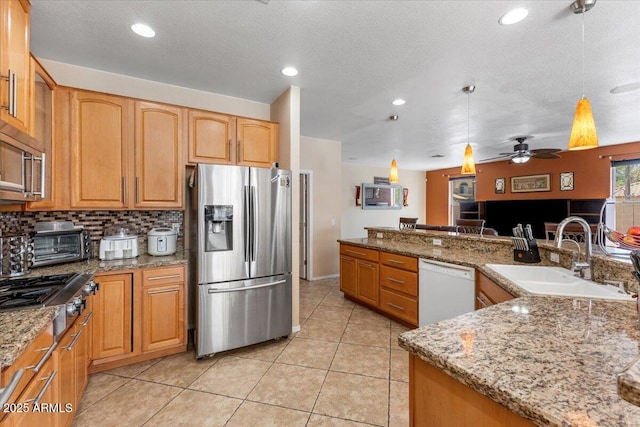 5212 S Monte Vista St, Chandler, AZ 85249 - kitchen with appliances with stainless steel finishes, a sink, light stone counters, hanging light fixtures, and recessed lighting