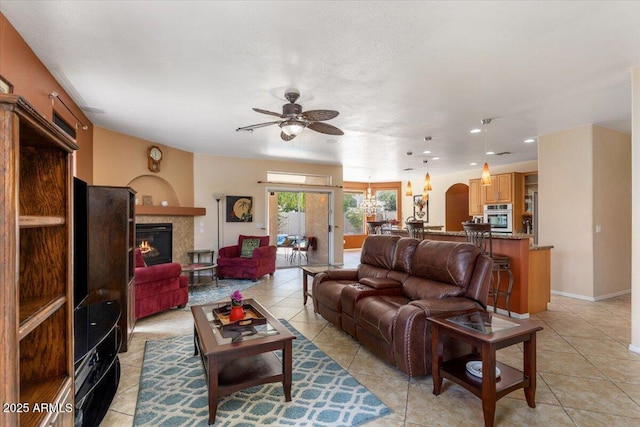 5212 S Monte Vista St, Chandler, AZ 85249 - living room featuring a ceiling fan, light tile patterned floors, a warm lit fireplace, and recessed lighting