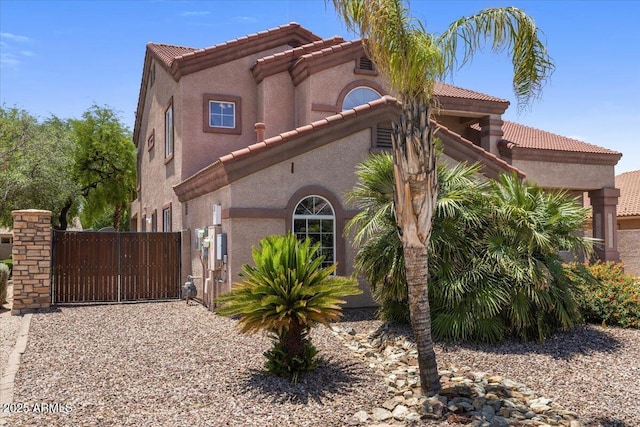 5212 S Monte Vista St, Chandler, AZ 85249 - view of front of house with a tiled roof, a gate, and stucco siding