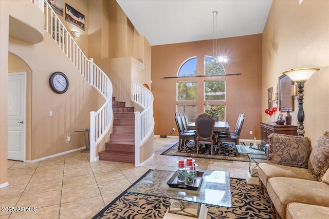 5212 S Monte Vista St, Chandler, AZ 85249 - living room with a high ceiling, stairway, arched walkways, tile patterned flooring, and baseboards