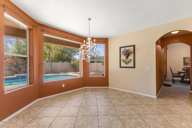 5212 S Monte Vista St, Chandler, AZ 85249 - spare room featuring a chandelier, light tile patterned floors, arched walkways, and baseboards