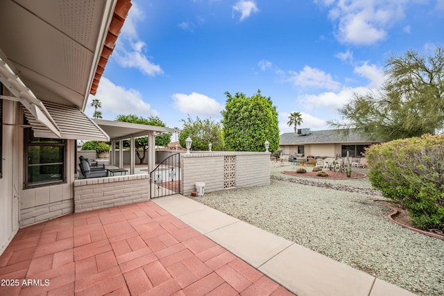 view of patio / terrace featuring a gate and fence