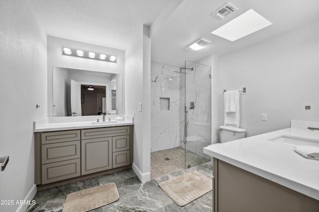 bathroom featuring a marble finish shower, vanity, marble finish floor, and visible vents
