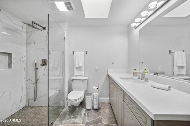 full bathroom featuring vanity, toilet, a marble finish shower, marble finish floor, and a skylight