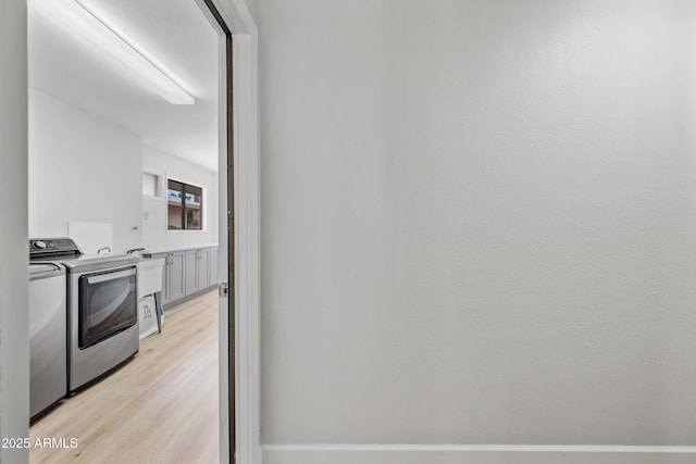 interior space featuring light wood-style floors and independent washer and dryer