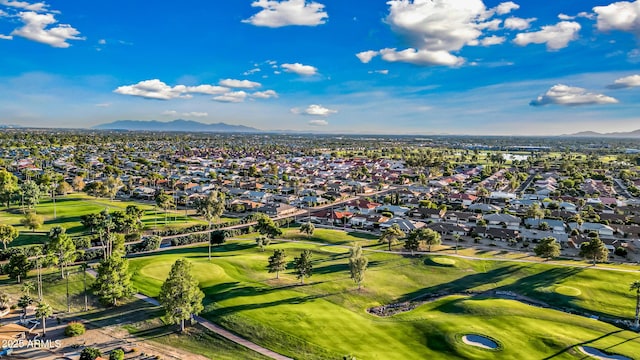 drone / aerial view with view of golf course, a mountain view, and a residential view