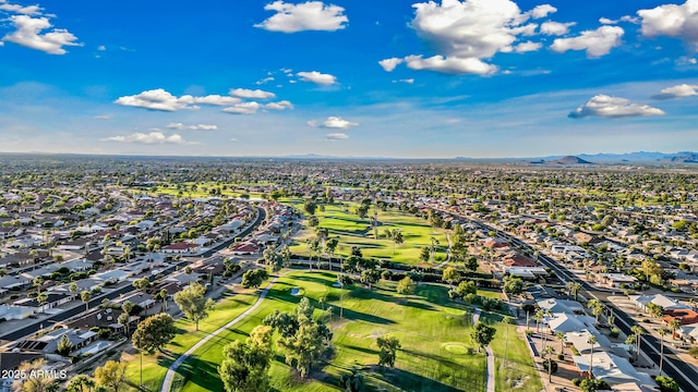 aerial view with view of golf course, a mountain view, and a residential view