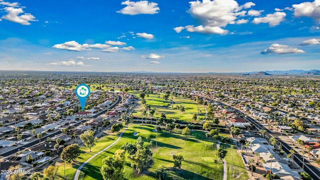 drone / aerial view featuring a residential view, a mountain view, and golf course view