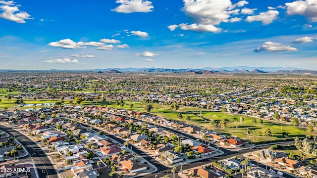 drone / aerial view featuring view of golf course, a residential view, and a mountain view