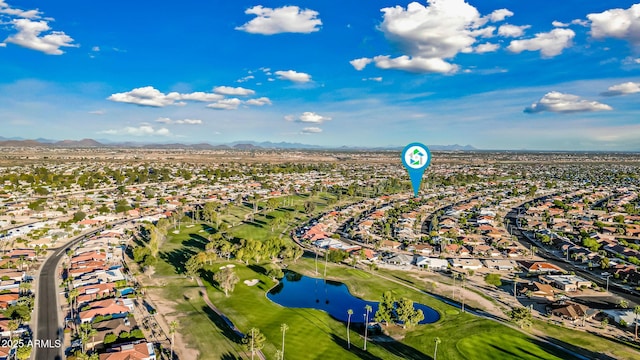 bird's eye view featuring a water and mountain view, view of golf course, and a residential view